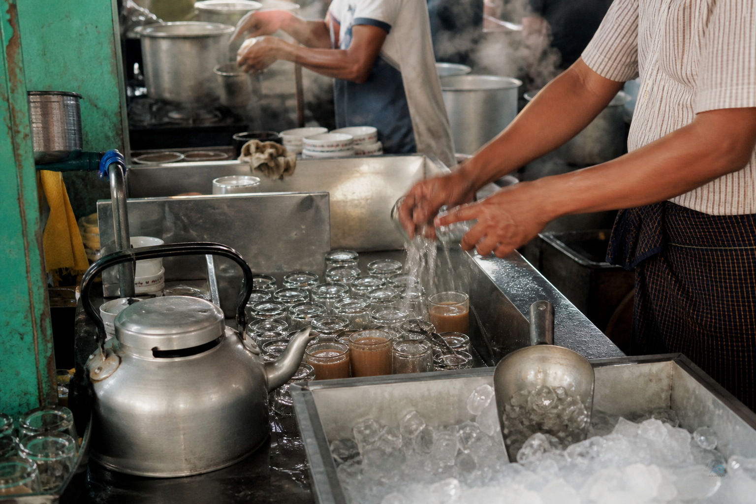 Tea cups, ice bin, and cooking prep competing for purified water