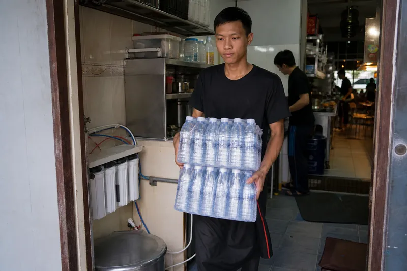 Staff buying bottled water while RO jug sits empty