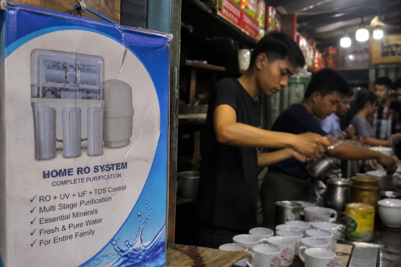 Home-class RO sticker next to a busy Yangon tea-shop counter