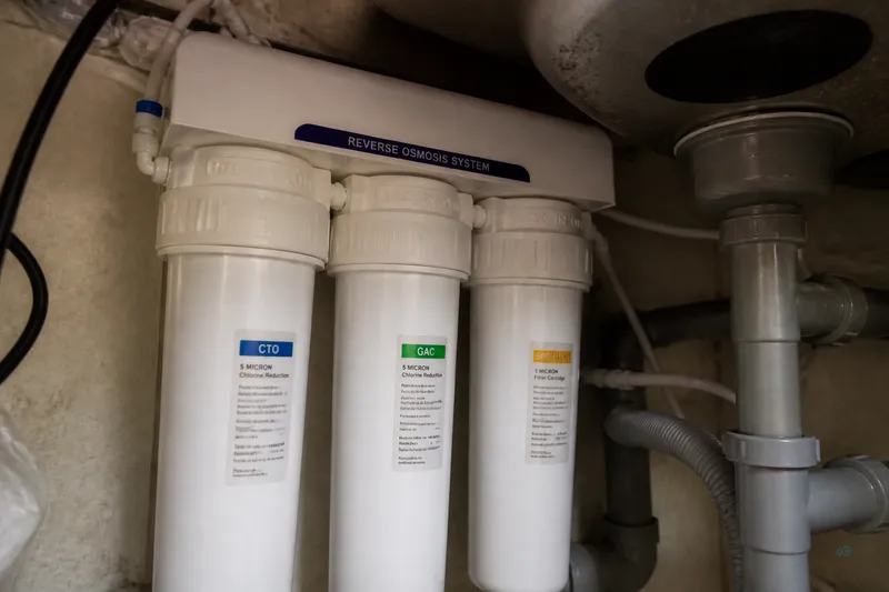Technician photographing RO filter housings right after install for future reorders