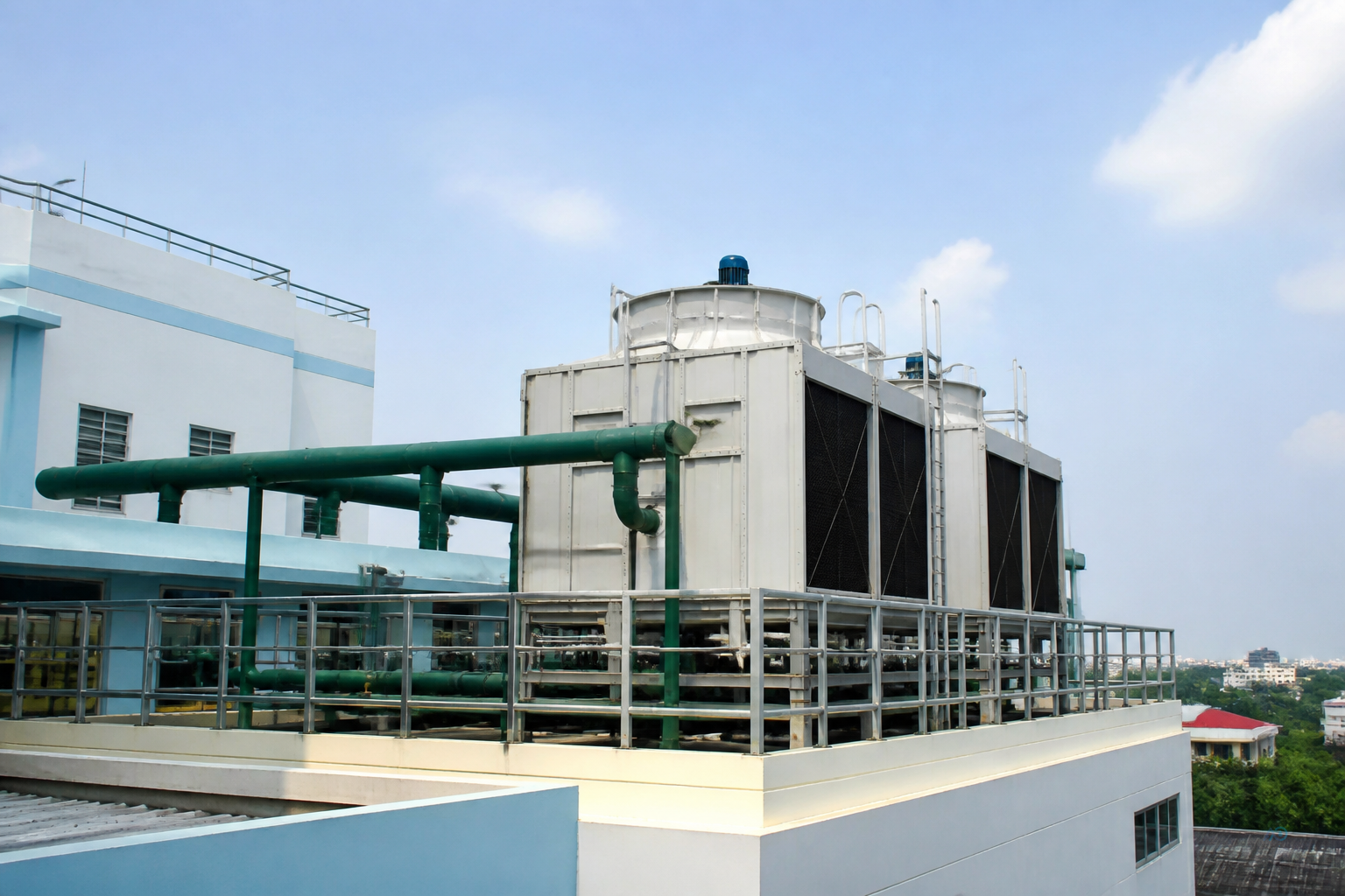 Myanmar hospital roof cooling tower with facility manager reviewing utility zoning map