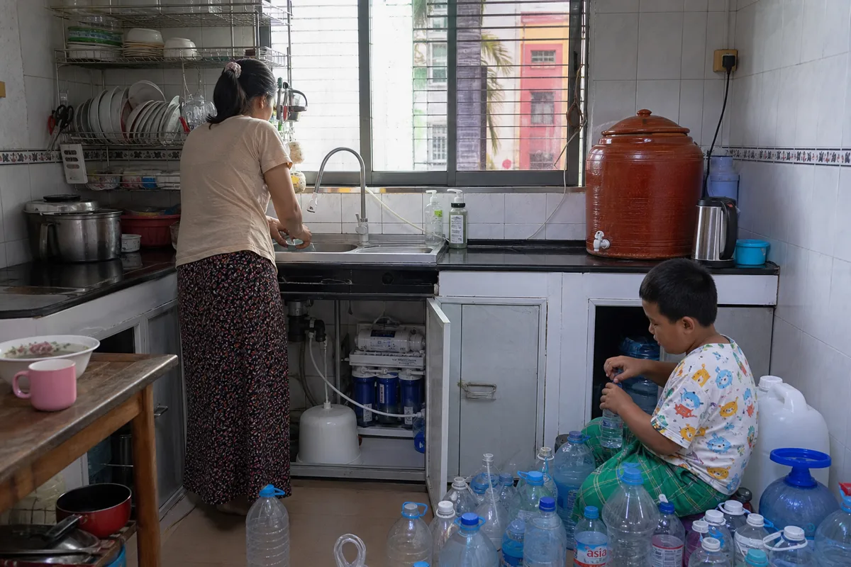 Myanmar household that outgrew a small under-sink RO — morning queue at the jug