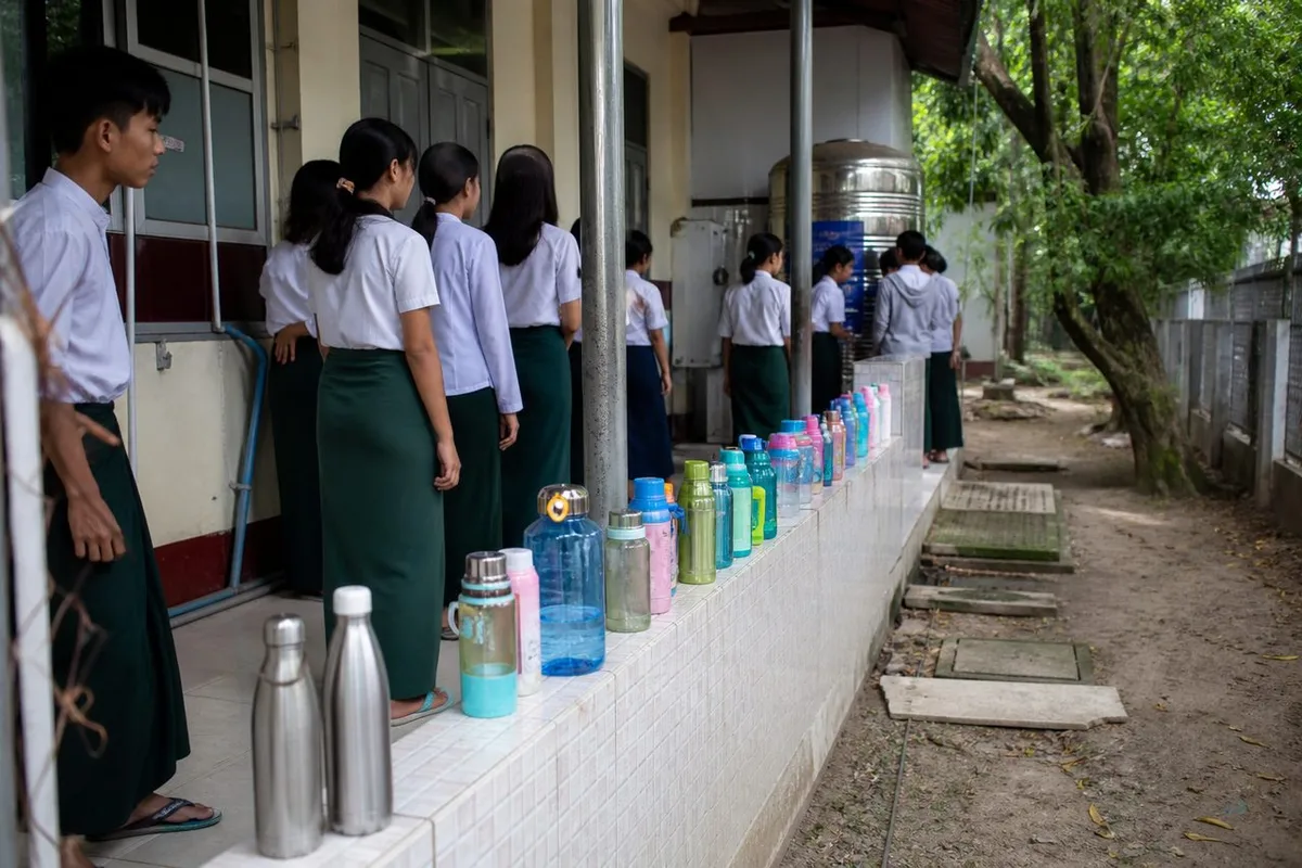 Yangon school-term morning — kids' bottles and kitchen rush on home RO