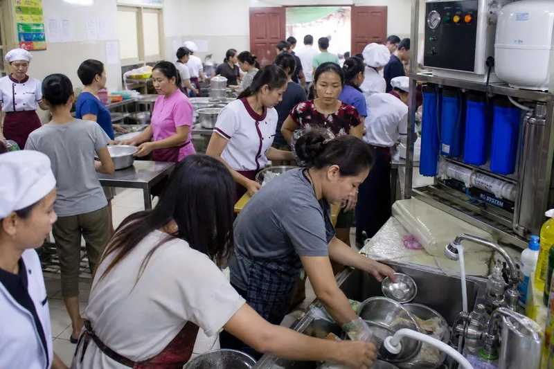 School-term peak hour — bottles, cooking and tea competing for purified water